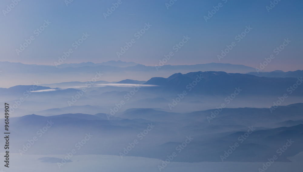 Amazing landscape of mountains weltered in mist