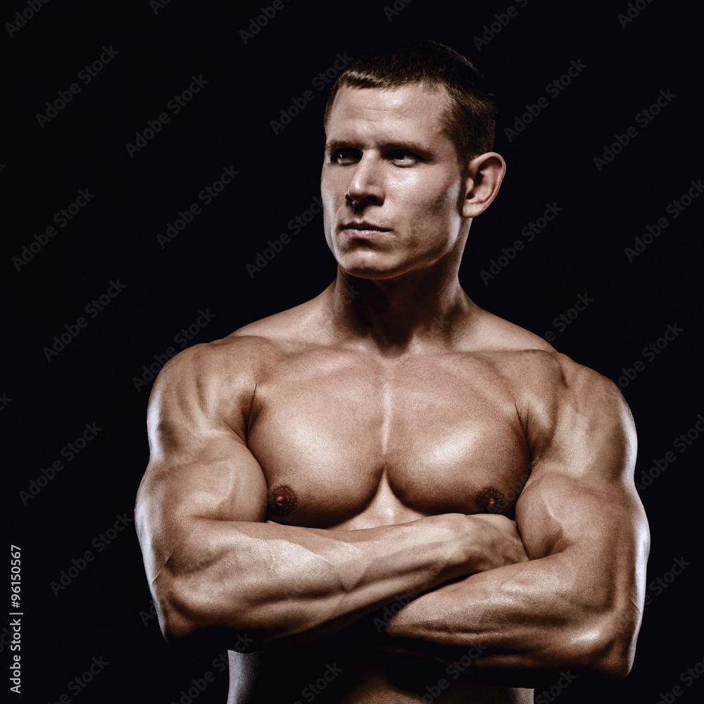 Fototapeta premium Muscular and fit young man bodybuilder fitness male model posing