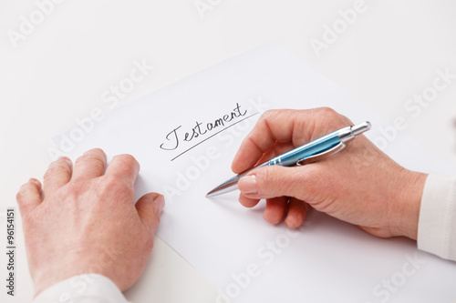 elderly woman writing testament photo