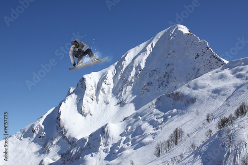flying snowboarder on mountains © Vasily Merkushev