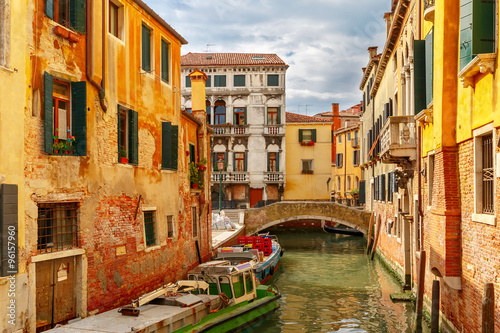 Colorful lateral canal and bridge in Venice, Italy © Kavalenkava