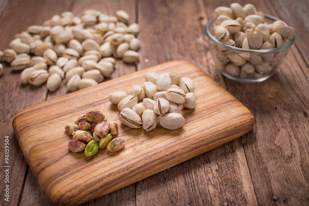Pistachio with a cup on wood texture Pistachio with a cup on wood texture
