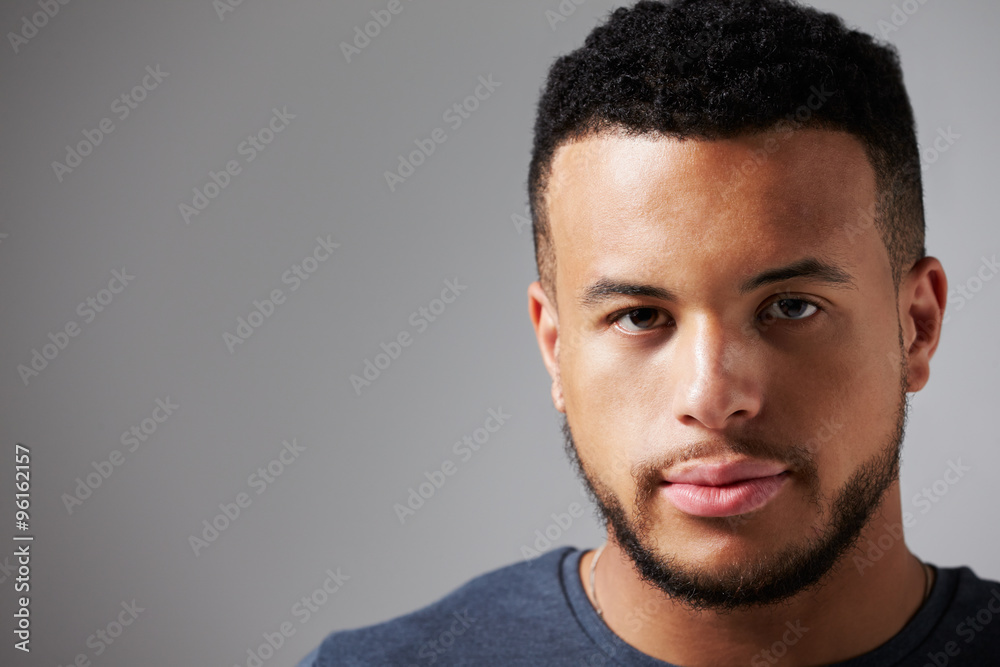 Studio Portrait Of Man Standing Against Grey Background Studio Portrait Of Man Standing Against Grey Background