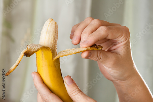 hands peeling a banana