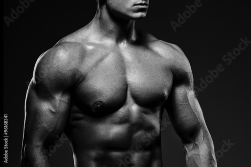 Close-up of a power fitness man. Strong and handsome young man w