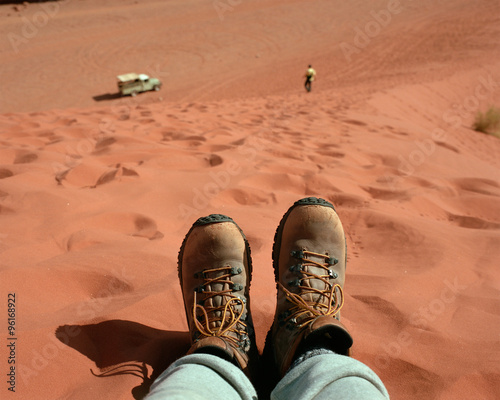 Hiker's feet on sandhill in Wadi Rum Desert, Jordan