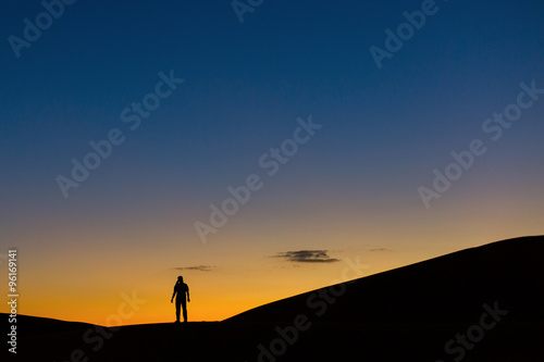 Sillhouette of man in desert at sunset © danmir12