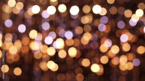 Abstract glittering lights, gold background, a real shot video in the blur