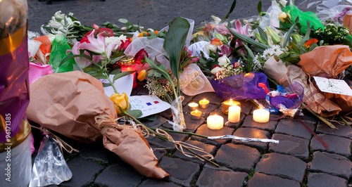Flowers and lit candles in front of the French Embassy in Piazza photo