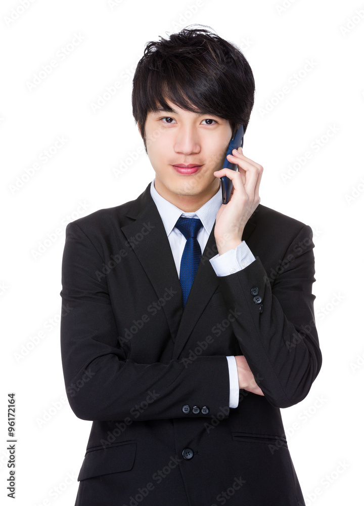 Asian Young Businessman talk to mobile phone Asian Young Businessman talk to mobile phone