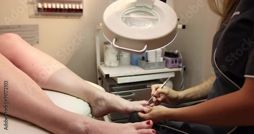 Toe Pedicure Dolly. camera moves right as spa client recives a pedicure on her foot by employee.
 photo