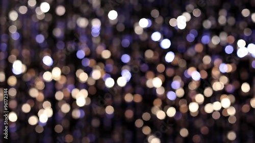 Abstract glittering lights, silver background, a real shot video in the blur