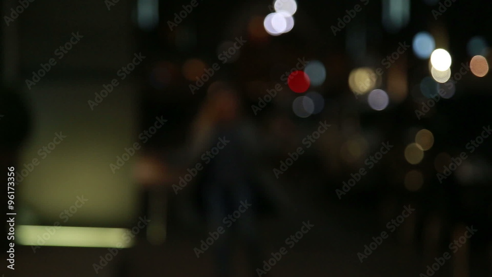 Young beautiful girl runs away from the camera in a blur on the night street Young beautiful girl runs away from the camera in a blur on the night street