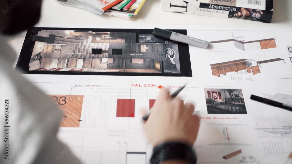 Top view of architects hands drawing of modern house