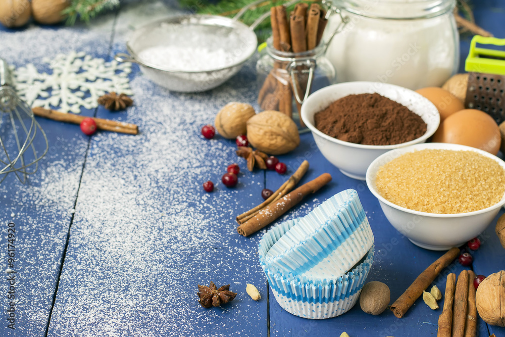 Ingredients for baking Christmas muffins on wooden background. s Ingredients for baking Christmas muffins on wooden background. s