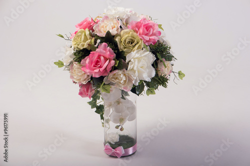 Artificial flowers bouquet in the vase isolated on white