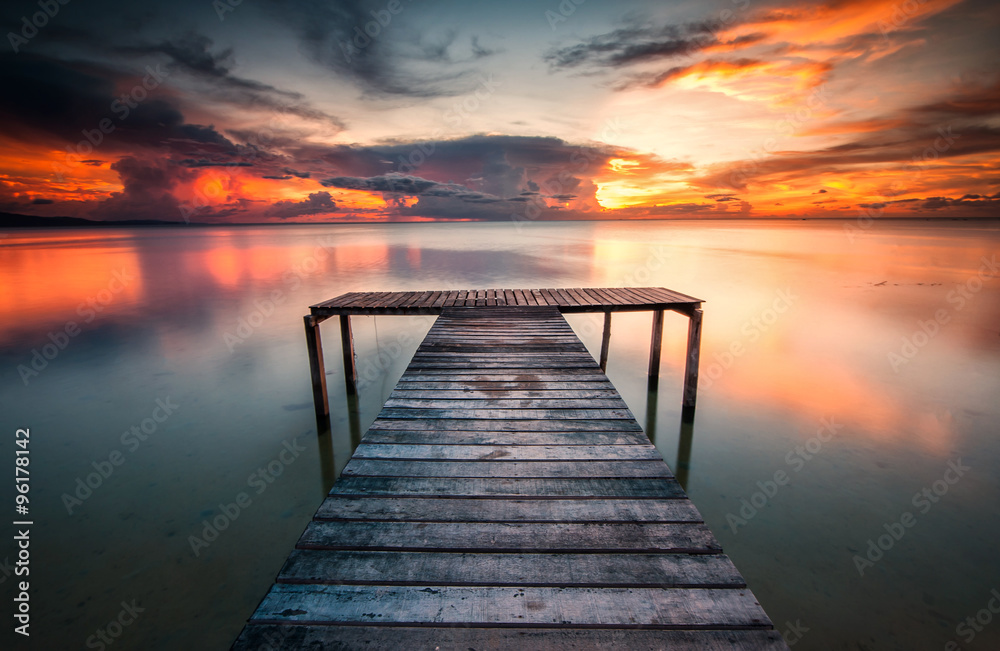 jetty and sunset with reflection