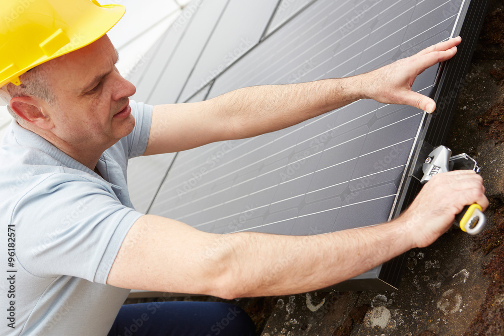 Engineer Installing Solar Panels On Roof Of House Engineer Installing Solar Panels On Roof Of House