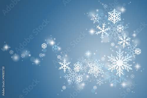 Winter holiday background with swirl of snowflakes on blue