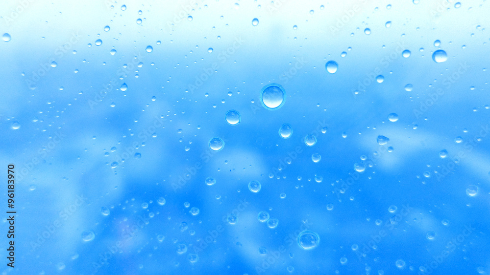 Close-up of water drops on glass surface as background Close-up of water drops on glass surface as background