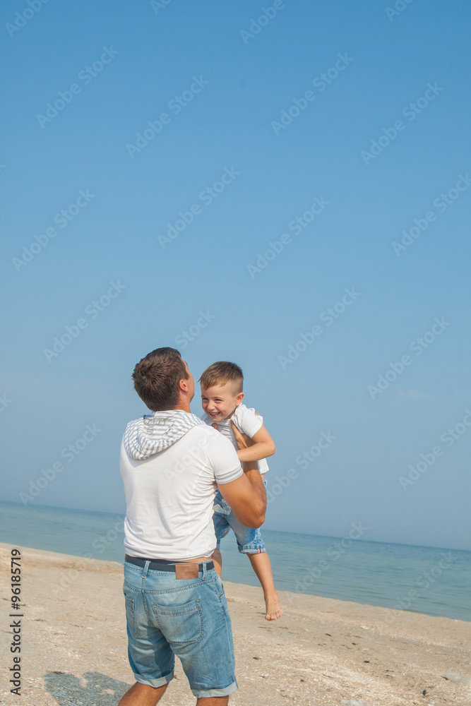Father and his son having fun on the beach Father and his son having fun on the beach