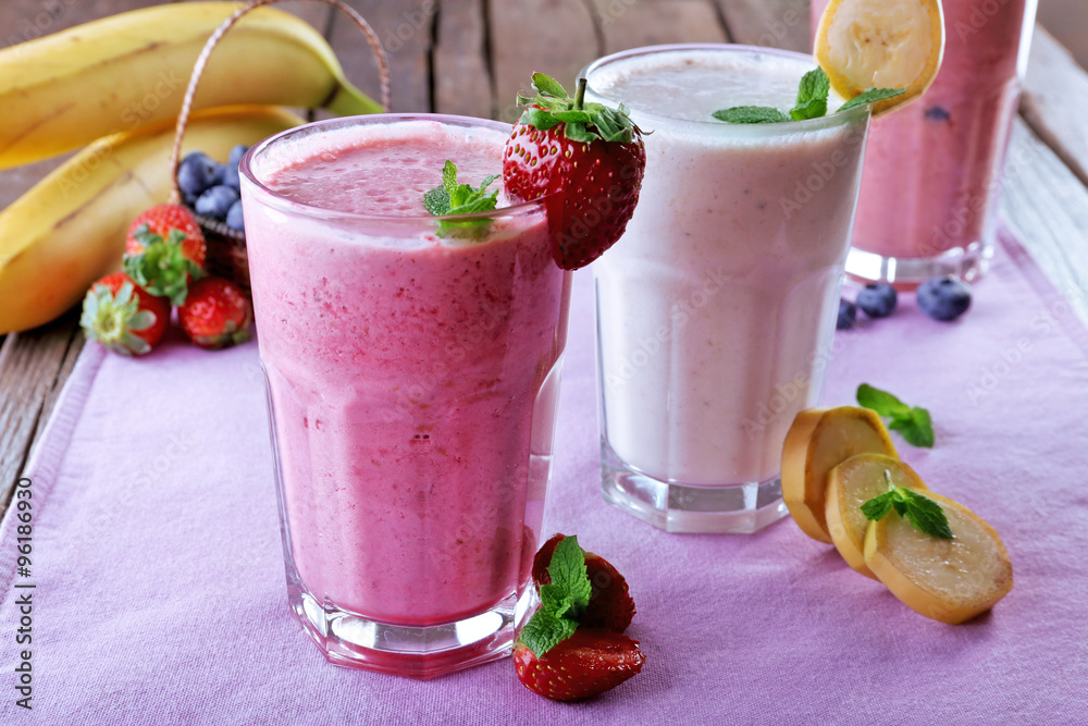 Glasses of fresh cold smoothie with fruit and berries, on the table, close-up Glasses of fresh cold smoothie with fruit and berries, on the table, close-up