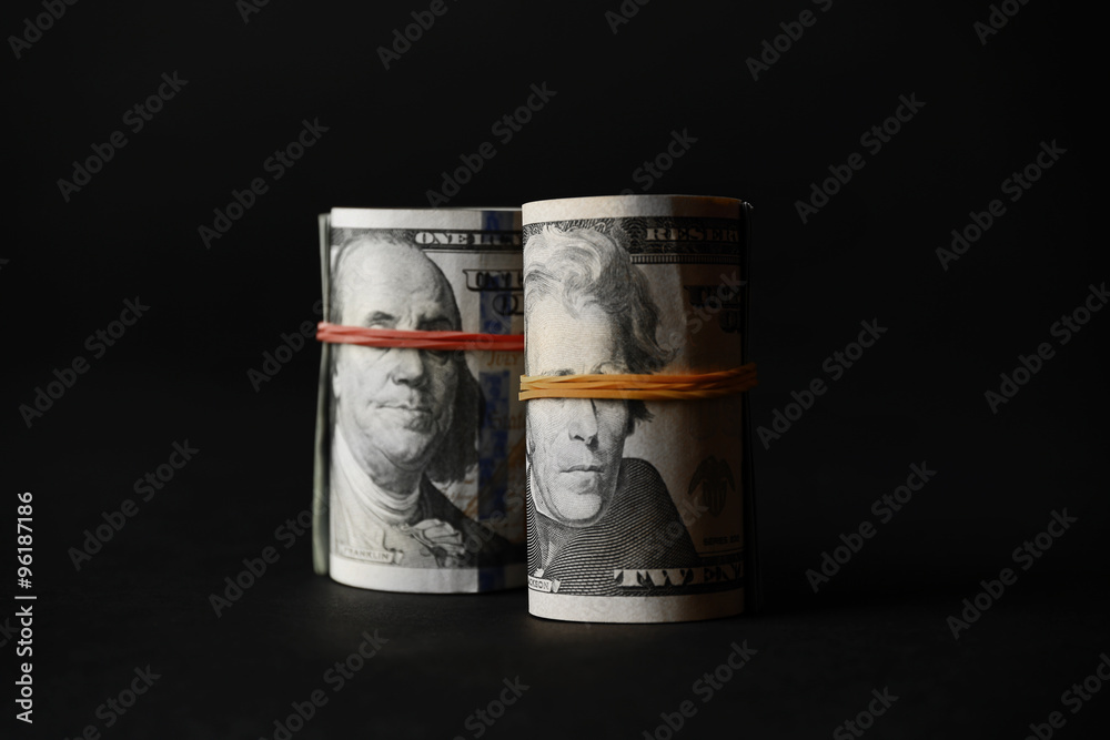 Dollars roll on black background Dollars roll on black background
