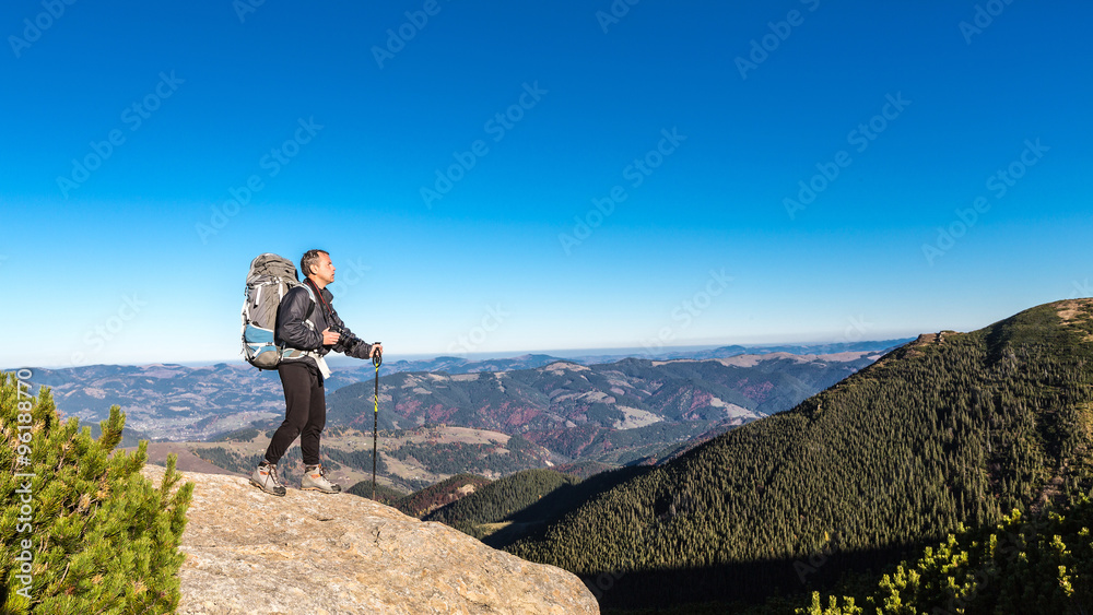 alone man on peak in carpathian mountains