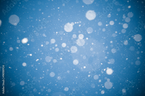 Winter background. falling snow on blue background