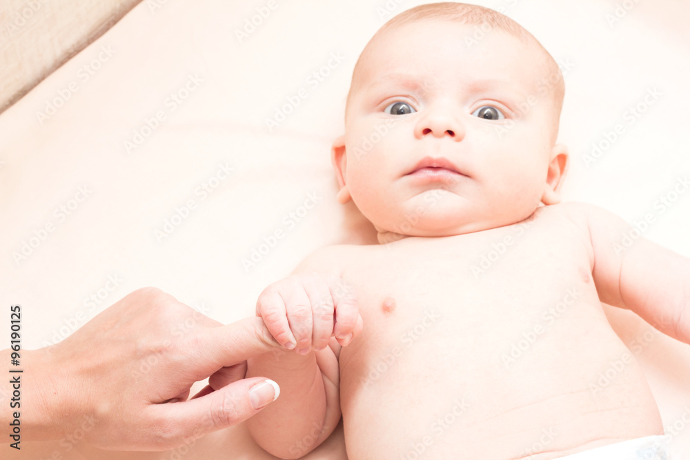 Mom holding the baby by the arm Mom holding the baby by the arm