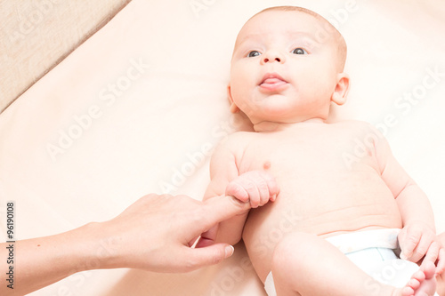 Mom holding the baby by the arm