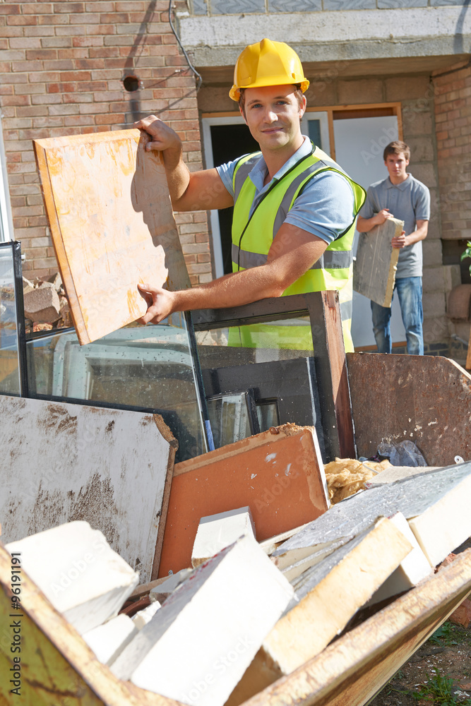 Builder Putting Waste Into Rubbish Skip Builder Putting Waste Into Rubbish Skip