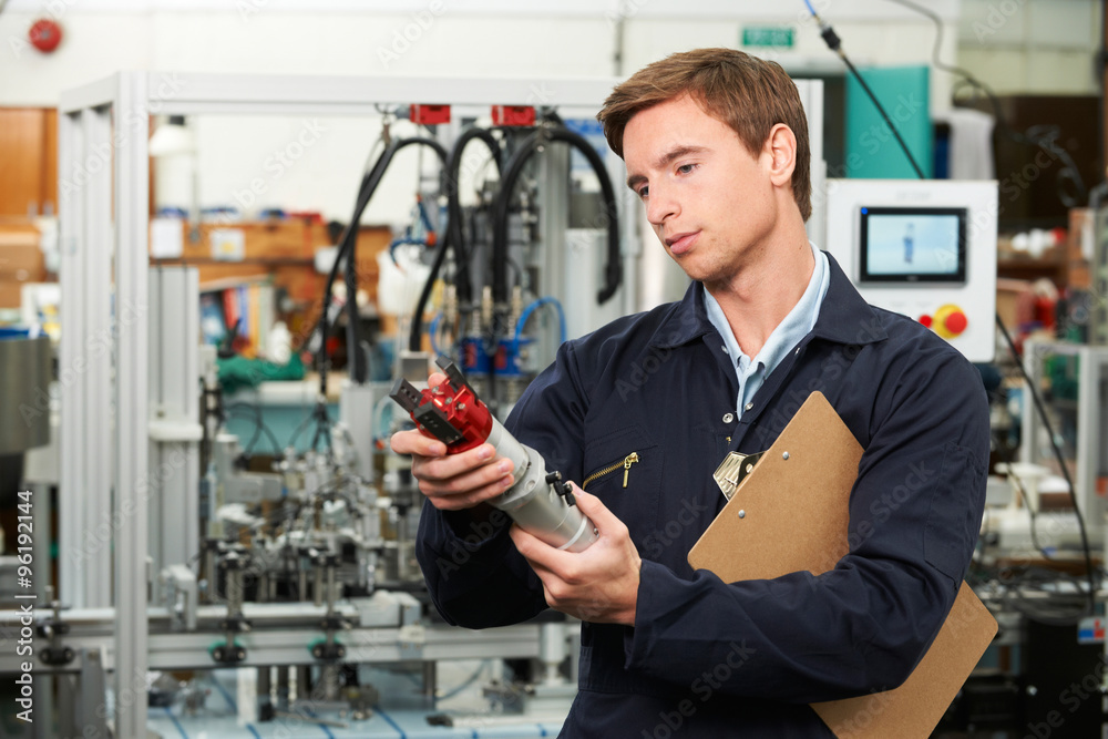 Engineer Inspecting Component In Factory Engineer Inspecting Component In Factory
