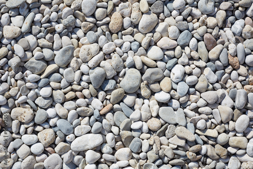 Pebbles on the beach, abstact stone background, sunlight Pebbles on the beach, abstact stone background, sunlight