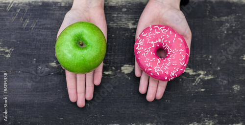 Choosing between apple and doughnut
  photo