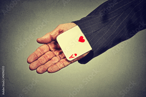 Canvas Print cropped image senior man hand pulling out a hidden ace from the sleeve