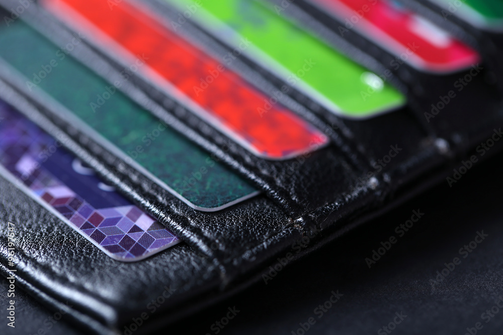 Black leather wallet with credit cards and money, close up Black leather wallet with credit cards and money, close up