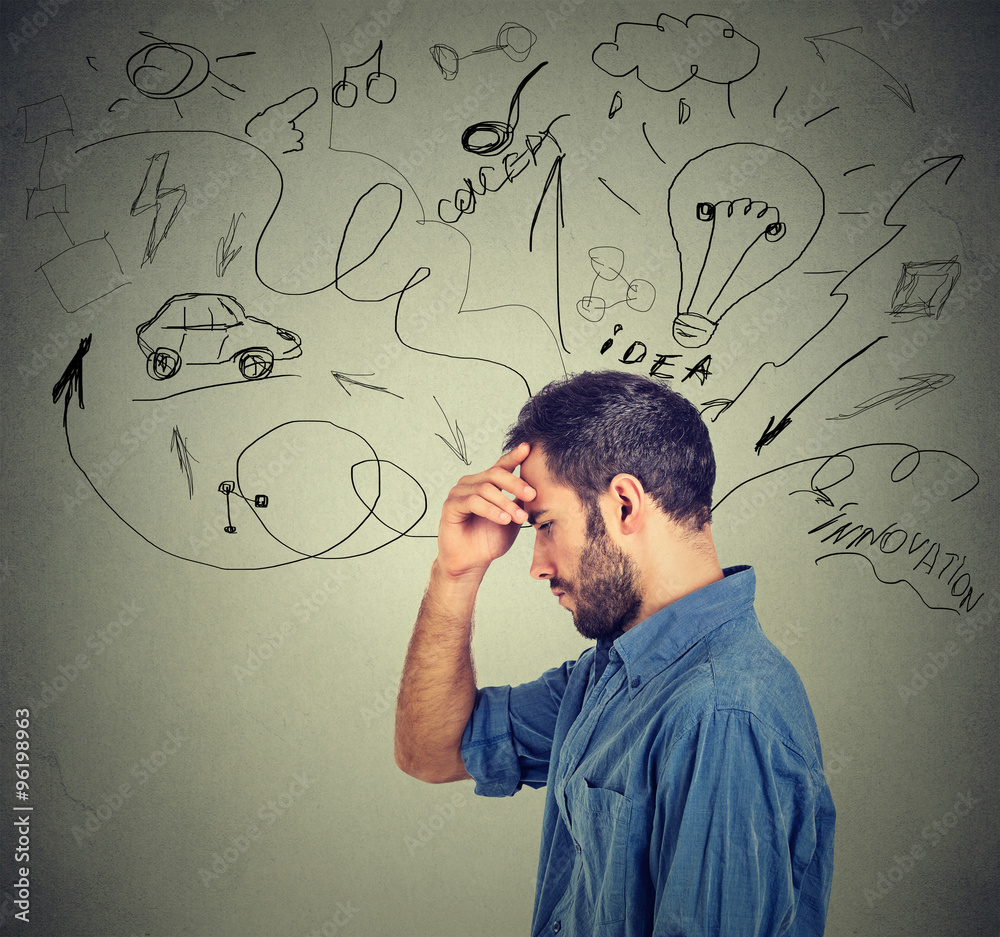 thoughtful man has many ideas looking down isolated on gray wall background thoughtful man has many ideas looking down isolated on gray wall background