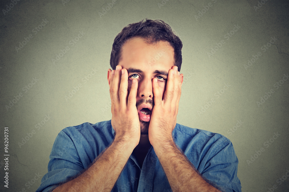 portrait of desperate unhappy man isolated on gray wall background portrait of desperate unhappy man isolated on gray wall background