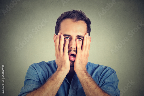 Cuadro en lienzo portrait of desperate unhappy man isolated on gray wall background