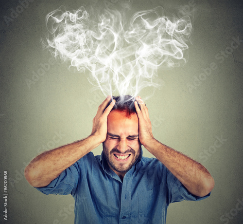 stressed man screaming thinking too hard steam coming out up of head photo