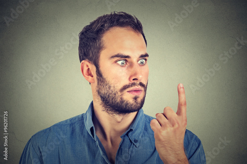 Shocked man looking at his finger