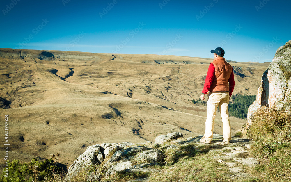 Male tourist looking at panoramic autumn landscape