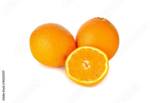 whole and cut ripe orange on white background