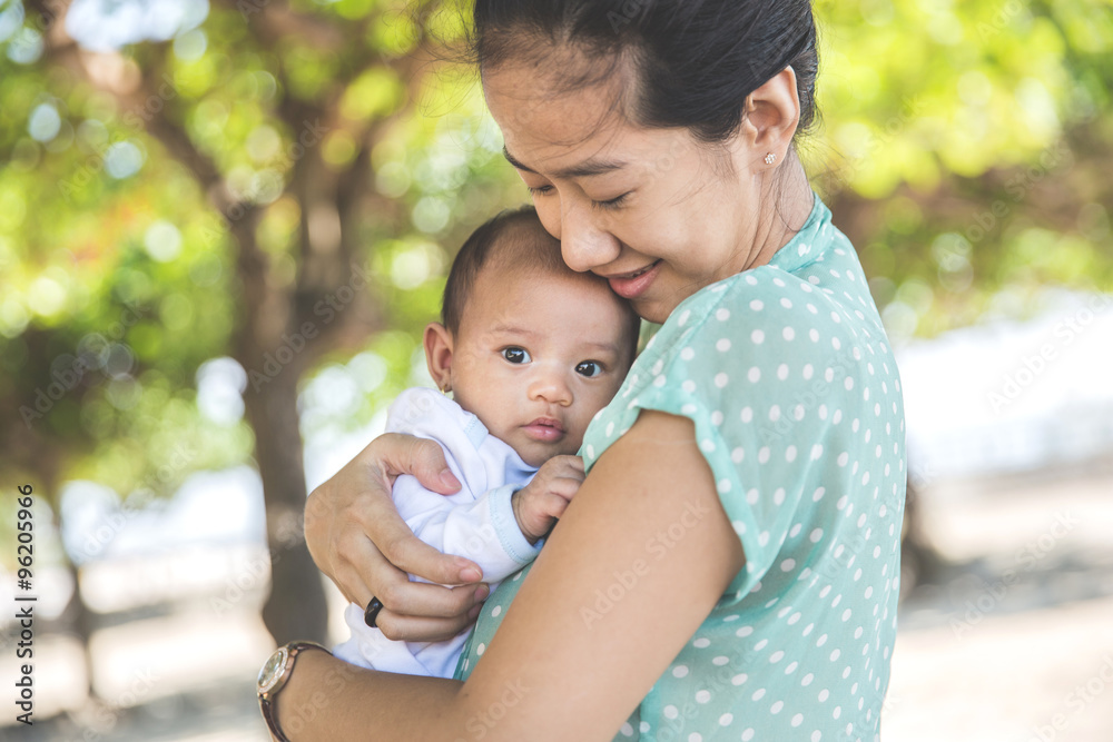 Woman holding her baby girl Woman holding her baby girl