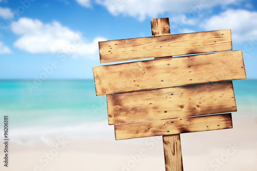 Vintage rustic wooden sign on the beach