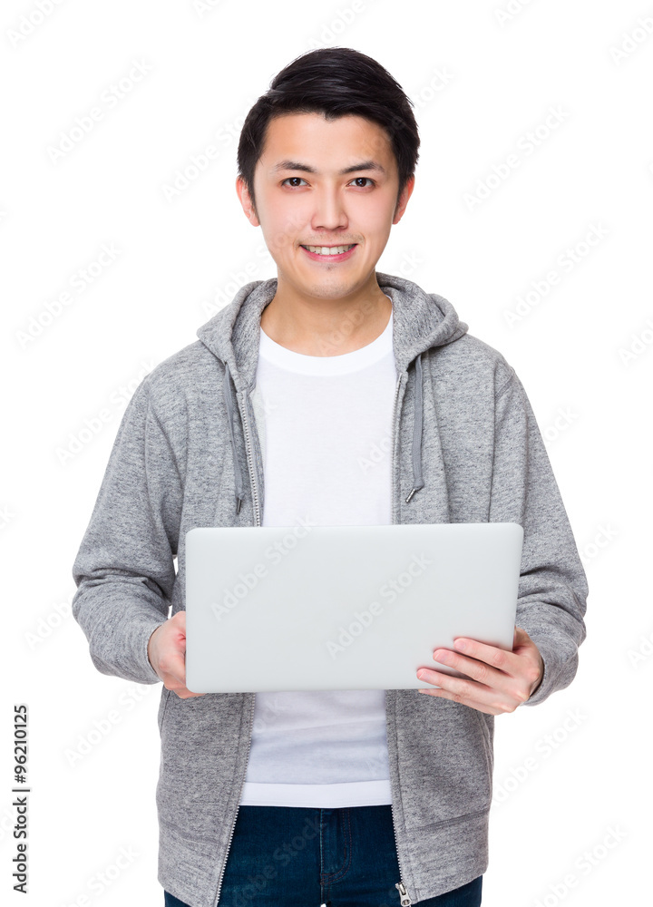 Asian Young man working with notebook computer Asian Young man working with notebook computer