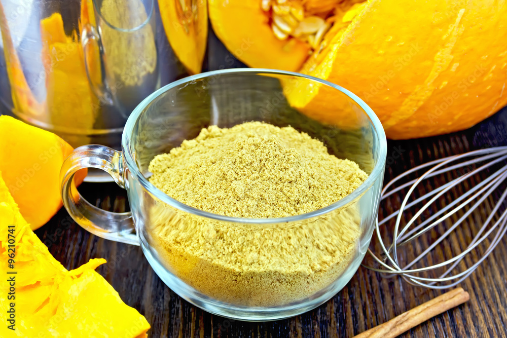 Flour pumpkin in glass cup with mixer on board Flour pumpkin in glass cup with mixer on board
