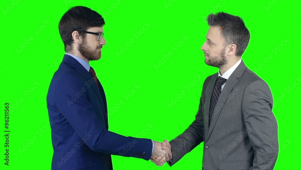 Two business partners shaking hands after reaching agreement Two business partners shaking hands after reaching agreement