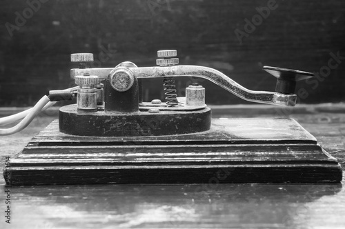 old morse key telegraph on wood table photo